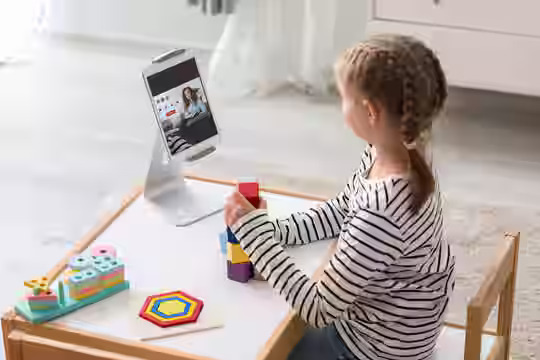 Teen in California using laptop for a telepsychiatry session at home