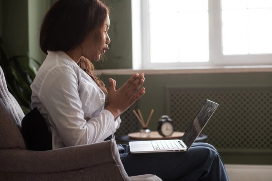 Woman in California attending an online psychiatry session covered by MHN insurance.
