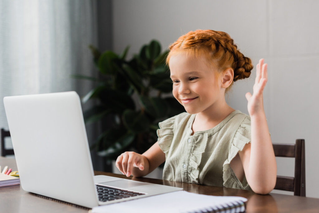 Child attending online psychiatry session with psychiatrist on laptop in California