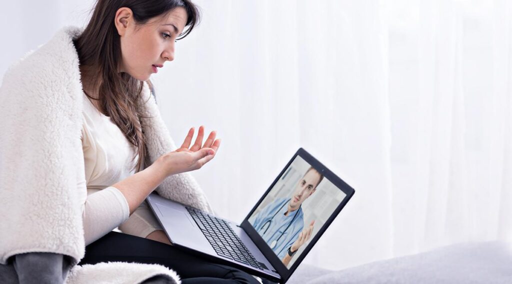 Individual in Roseville having online psychiatric session on a laptop